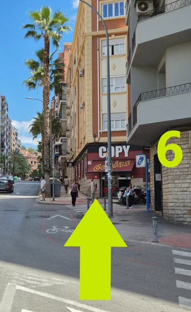 You will see the copy shop sign. You are almost there: simply enter San Juan Bosco along the copy shop pavement